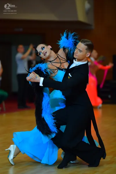 Dancesport competitor: Male dancer: black tailcoat suit with a white shirt and white bowtie, featuring 