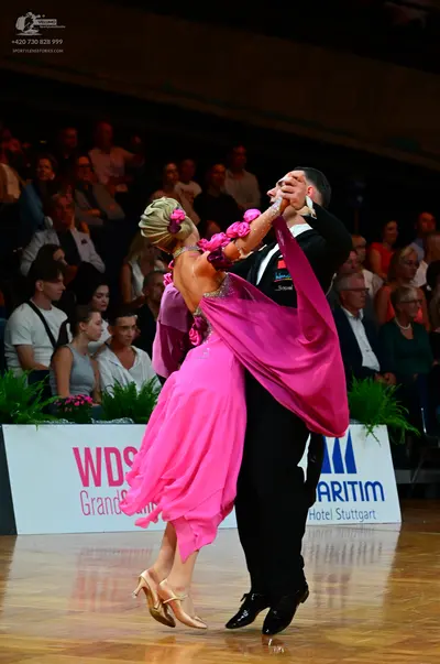 Dancesport competitor: Male dancer: black suit with a waistcoat and trousers, and black dance shoes