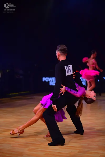 Dancesport competitor: Male dancer: black long-sleeved shirt and black trousers