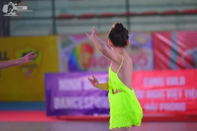 Dancesport competitor: ** Red
*   **Fabric:** Red satin
*   **Style:** Latin dress
*   **Accessories:**