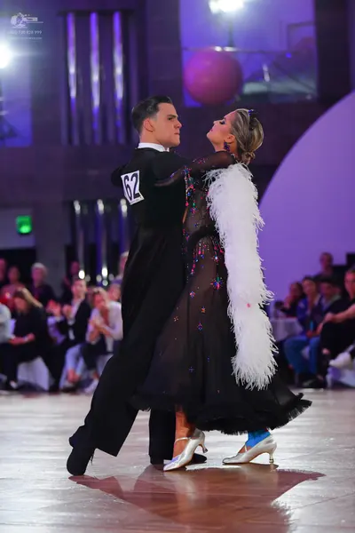 Dancesport competitor #62: Male dancer: black suit with a white shirt collar
