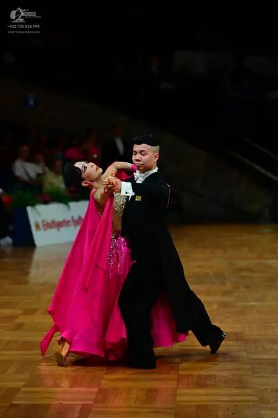 Dancesport competitor: Male dancer: black ballroom suit with a white shirt