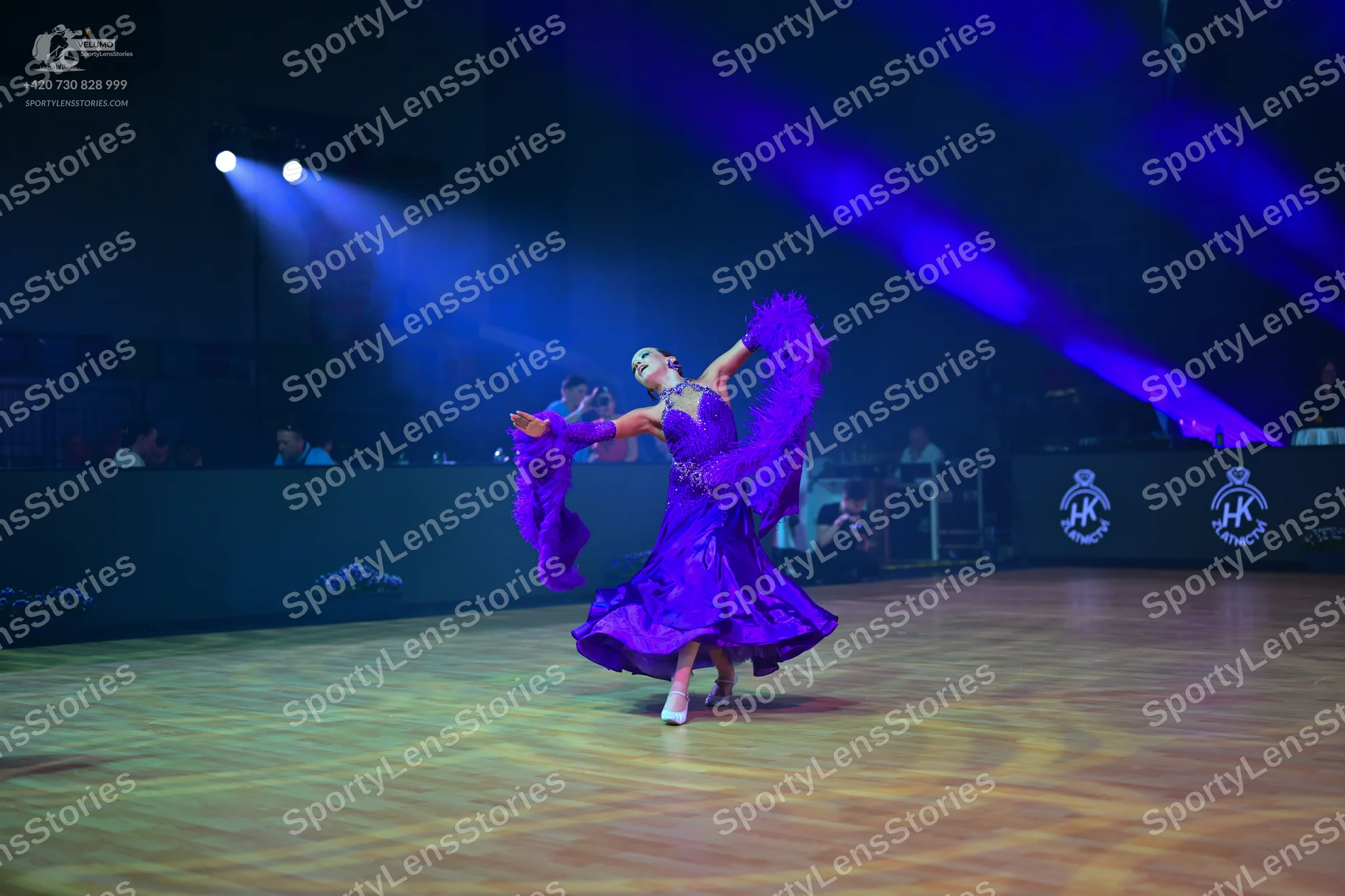 Dancesport competitor: Female dancer: purple ballgown with a large, voluminous skirt and long, flowing