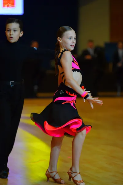 Dancesport competitor: Male dancer: black long-sleeved top and black trousers with a black belt