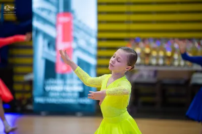 Dancesport competitor: ** Light Yellow
*   **Fabric:** Lace
*   **Style:** Fitted bodice with long, she
