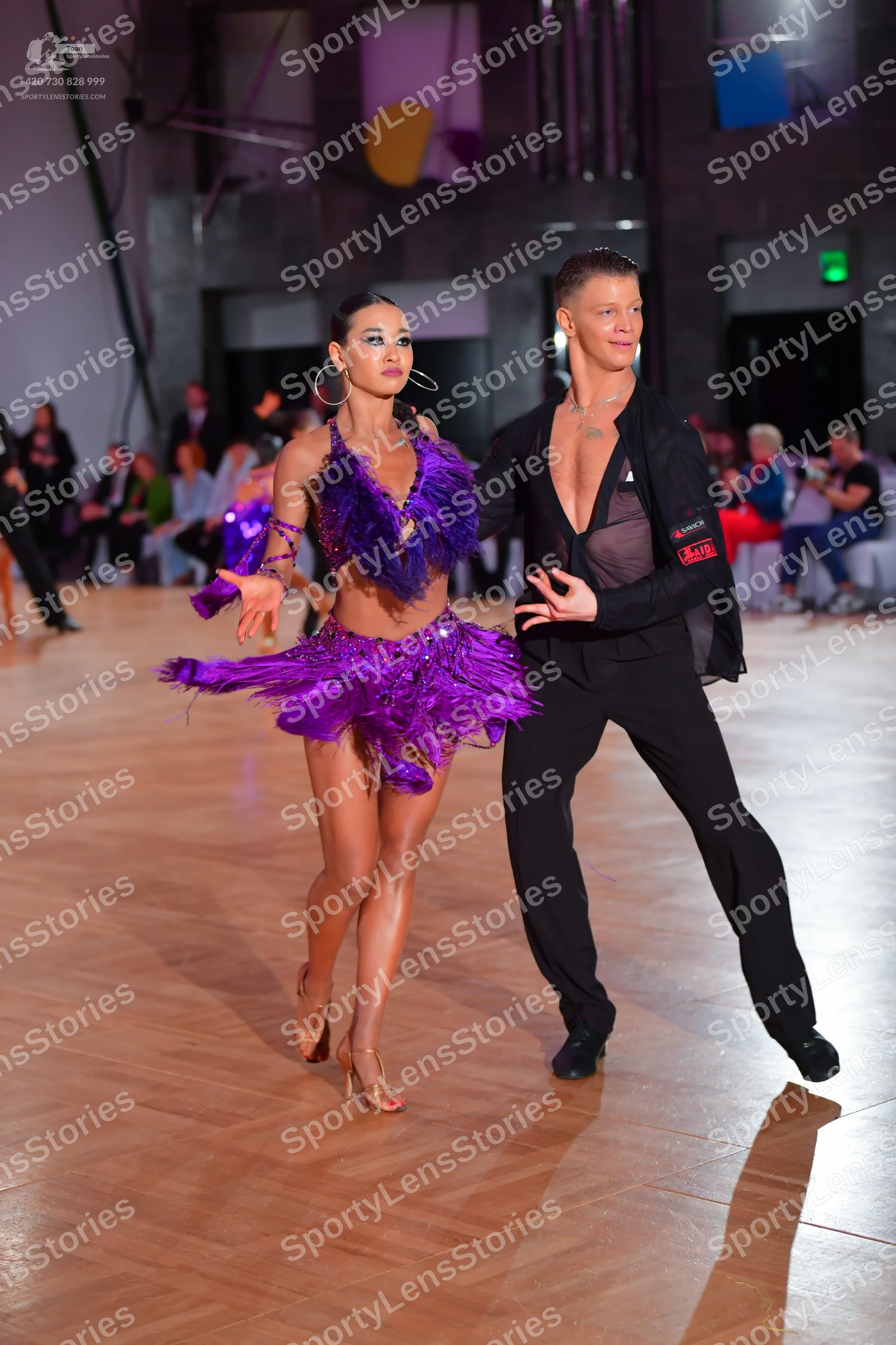 Dancesport competitor: Male dancer: black, somewhat sheer, unbuttoned shirt and black trousers