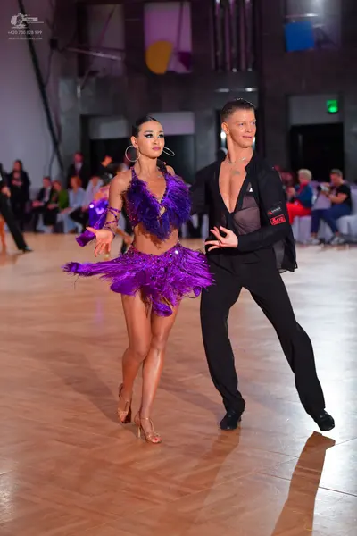 Dancesport competitor: Male dancer: black, somewhat sheer, unbuttoned shirt and black trousers