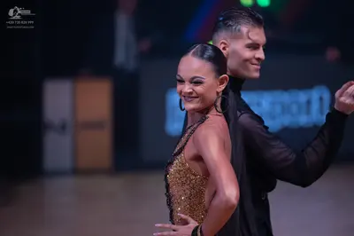 Dancesport competitor: Male dancer: black long-sleeved top