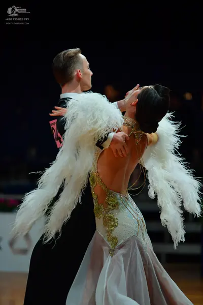 Dancesport competitor: Male dancer: black suit with a white shirt and black bowtie