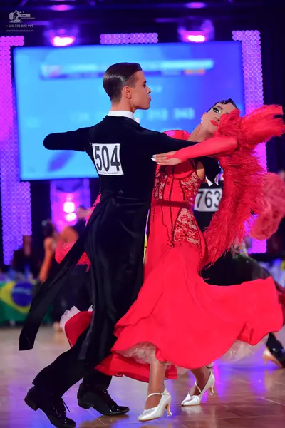 Dancesport competitor #504, #763: Male dancer: black long-sleeved shirt and black trousers