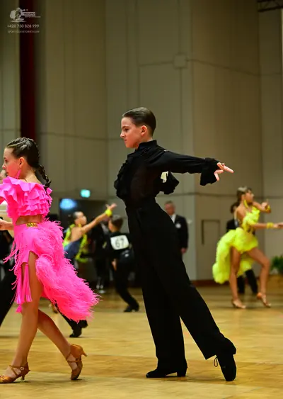 Dancesport competitor #67: Female dancer (foreground): pink latin dress with heavy fringe