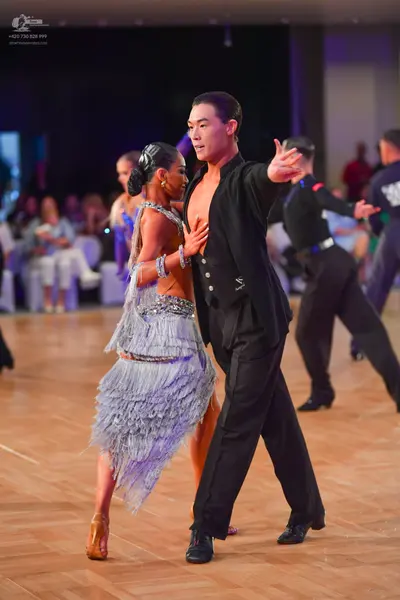 Dancesport competitor: Male dancer: black long-sleeved shirt and black trousers