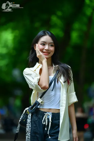 Dancesport competitor: Female dancer: white cropped top, off-white unbuttoned long-sleeve shirt, and da