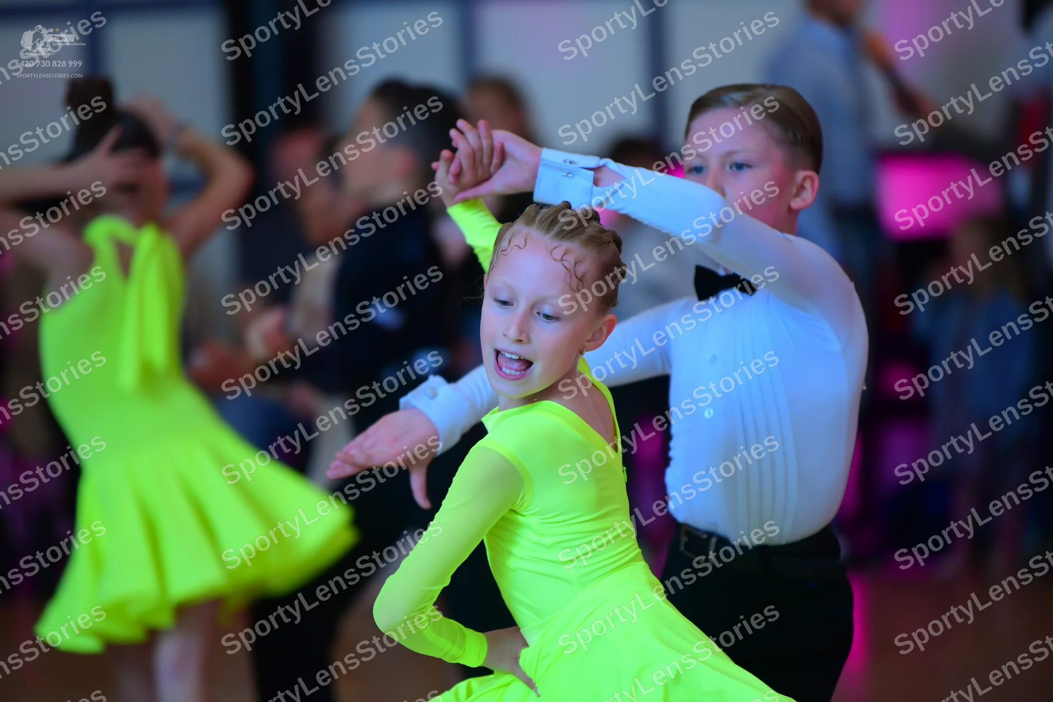 Dancesport competitor: Female dancer: neon lime green long-sleeved Latin dress
