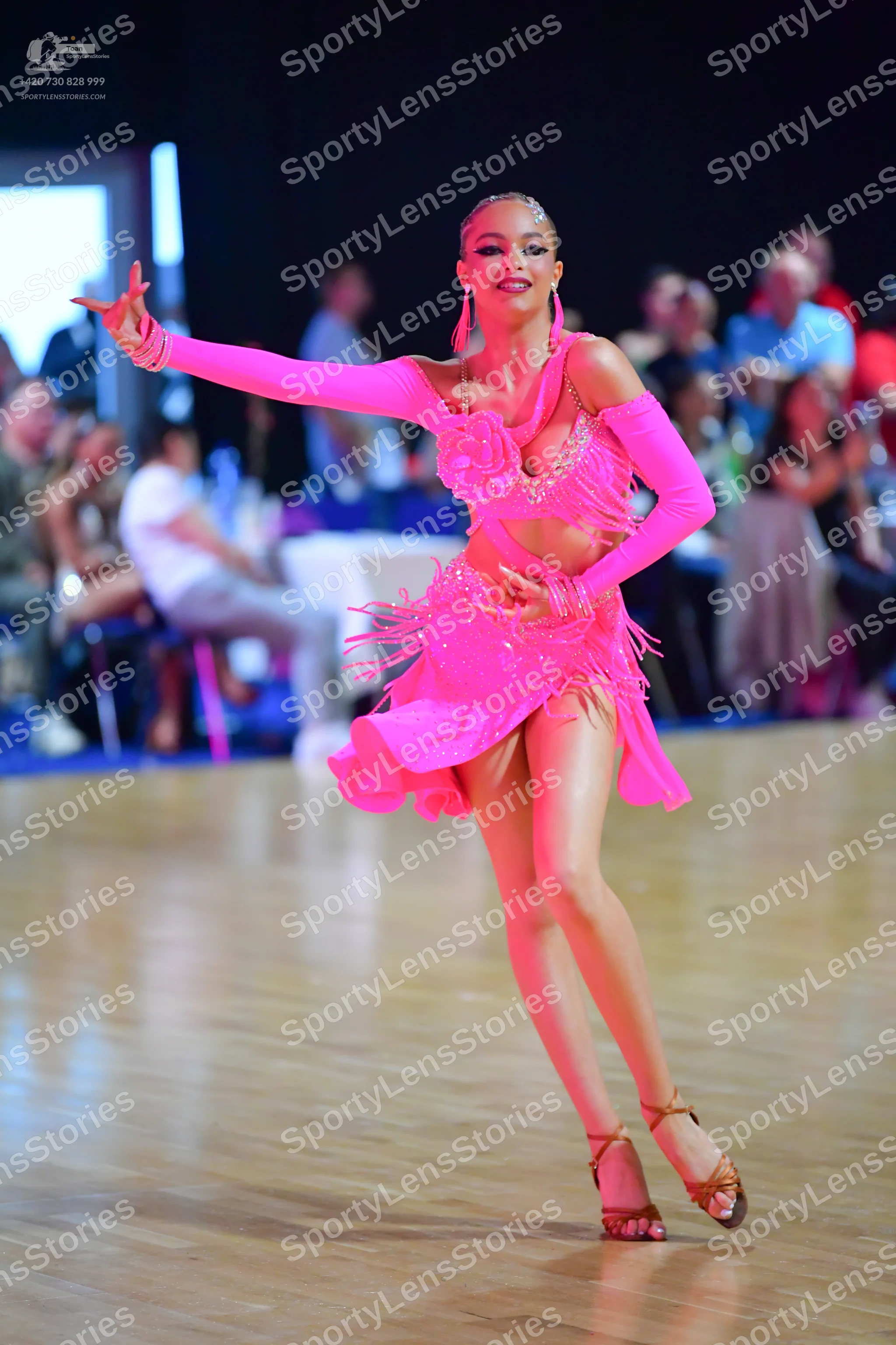 Dancesport competitor: Female dancer: bright pink latin dress with sequins and fringe