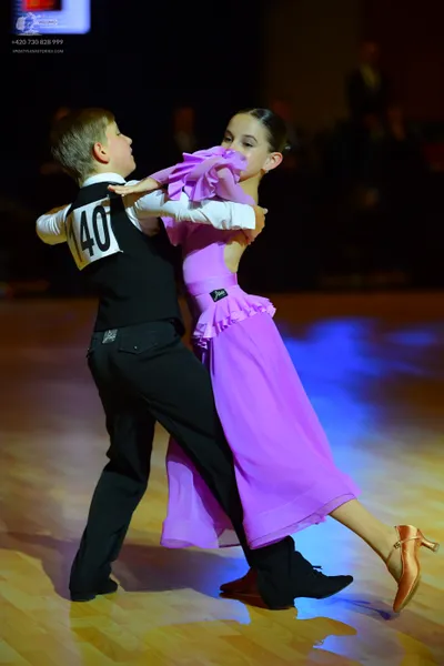 Dancesport competitor #140: Male dancer: black vest, white long-sleeved shirt, and black trousers
