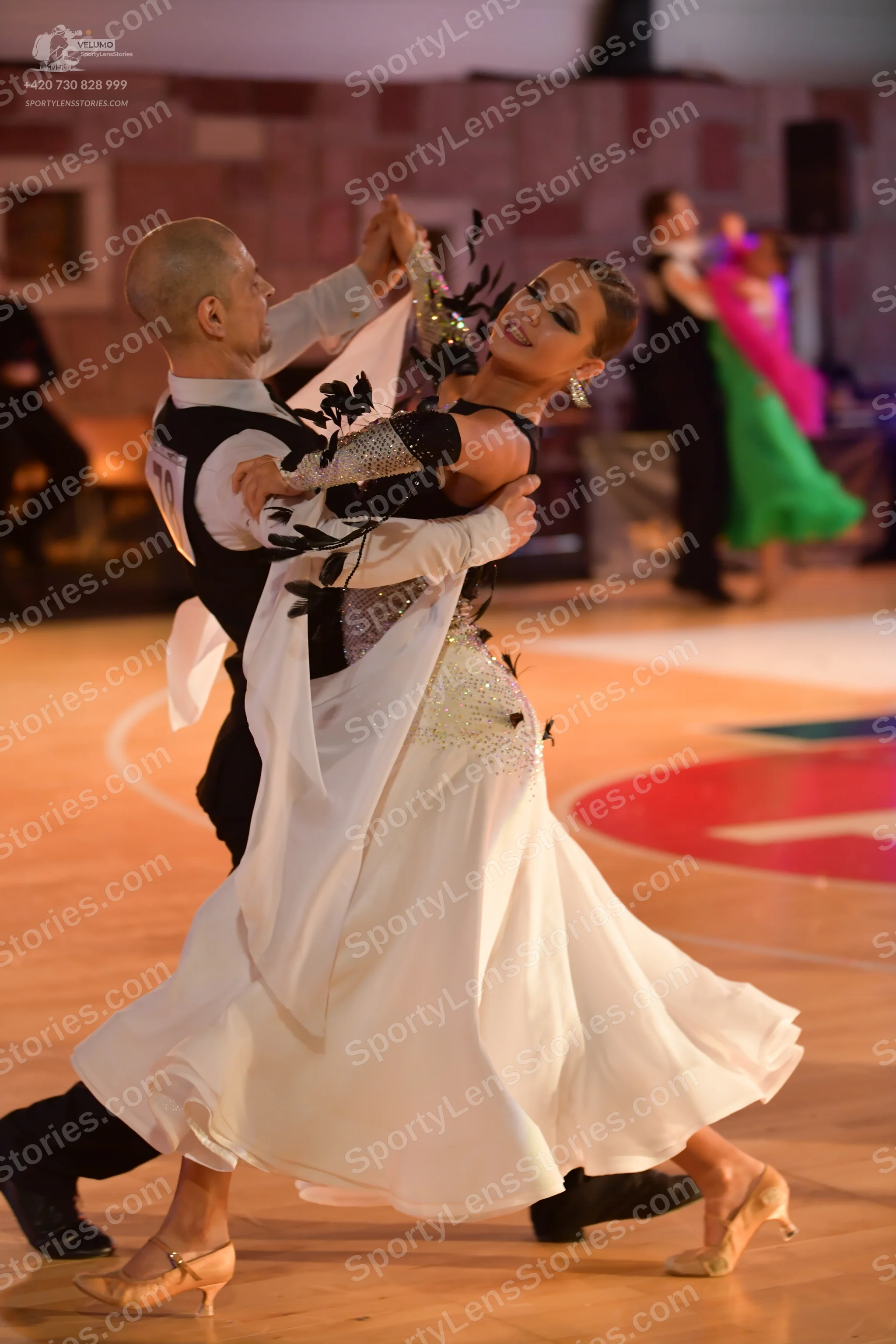 Dancesport competitor: Male dancer: black and white ballroom suit with large patterned white/silver ele