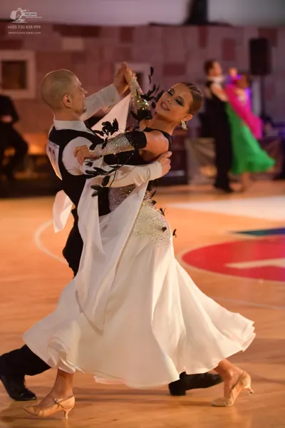 Dancesport competitor: Male dancer: black and white ballroom suit with large patterned white/silver ele
