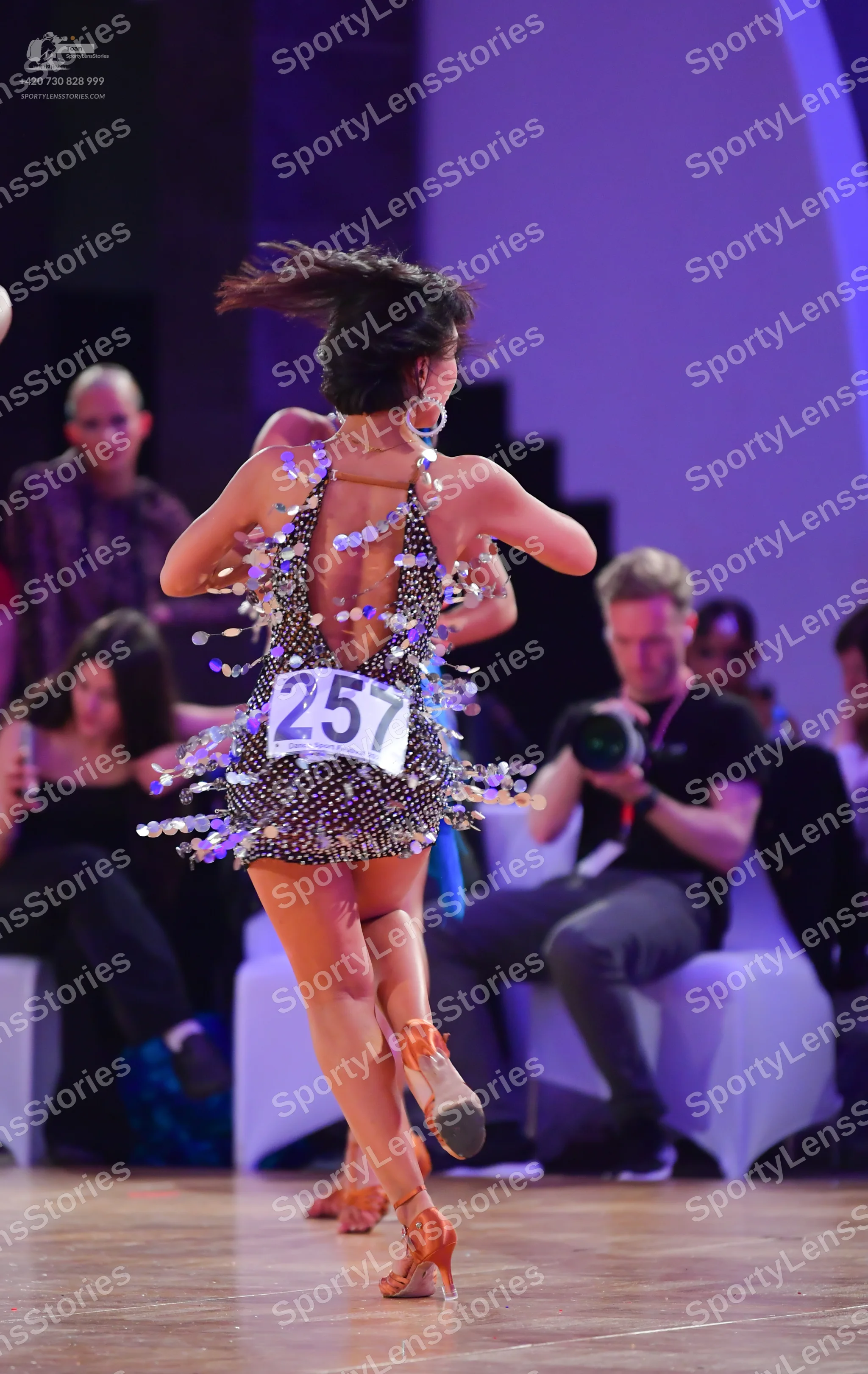 Dancesport competitor #257: Female dancer: dark-colored short Latin dress with a pattern of small silver seq