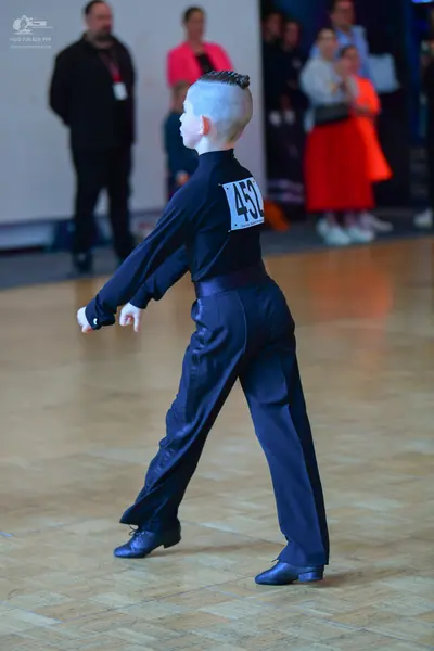 Dancesport competitor #452: Male dancer: dark navy or black long-sleeved top and matching trousers made of a