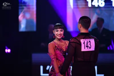 Dancesport competitor: Male dancer: black latin dance top with sheer mesh panels and small sequins