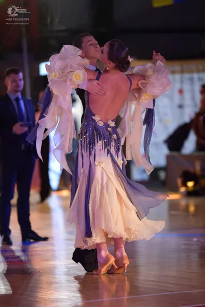 Dancesport competitor: Male dancer: black suit with white shirt and dark tie