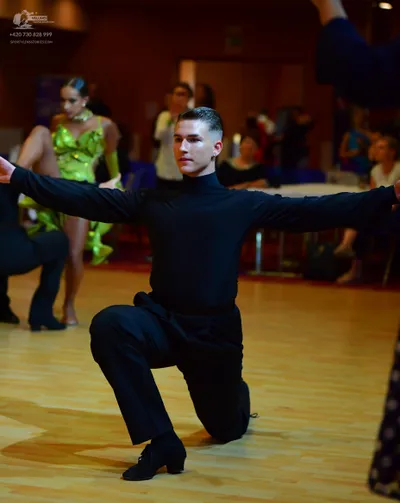Dancesport competitor: Male dancer: black long-sleeved turtleneck and black trousers