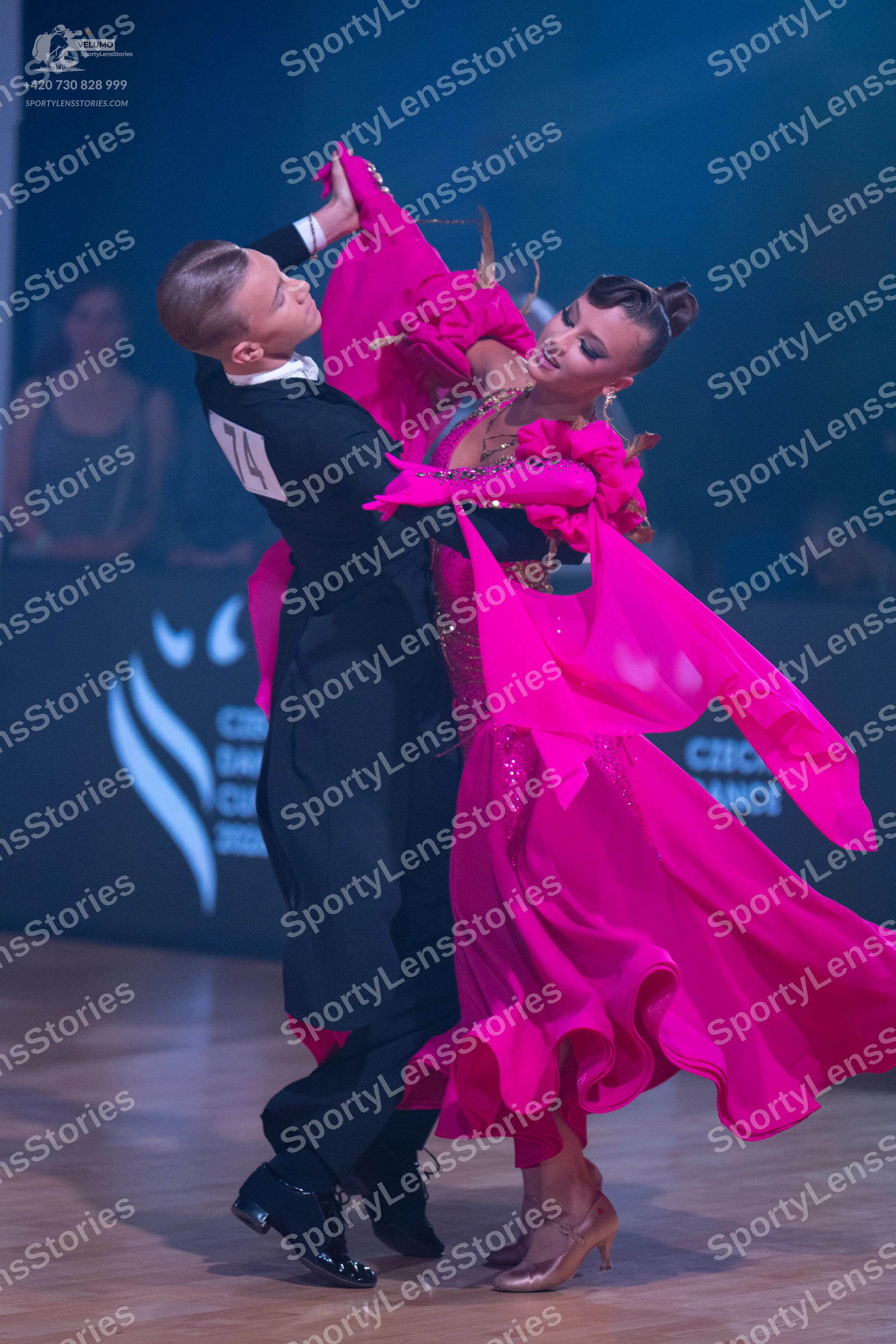 Dancesport competitor: Male dancer: black long-sleeved top and black trousers with black sequined dance