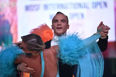 Dancesport competitor: Male dancer: black suit with a white shirt