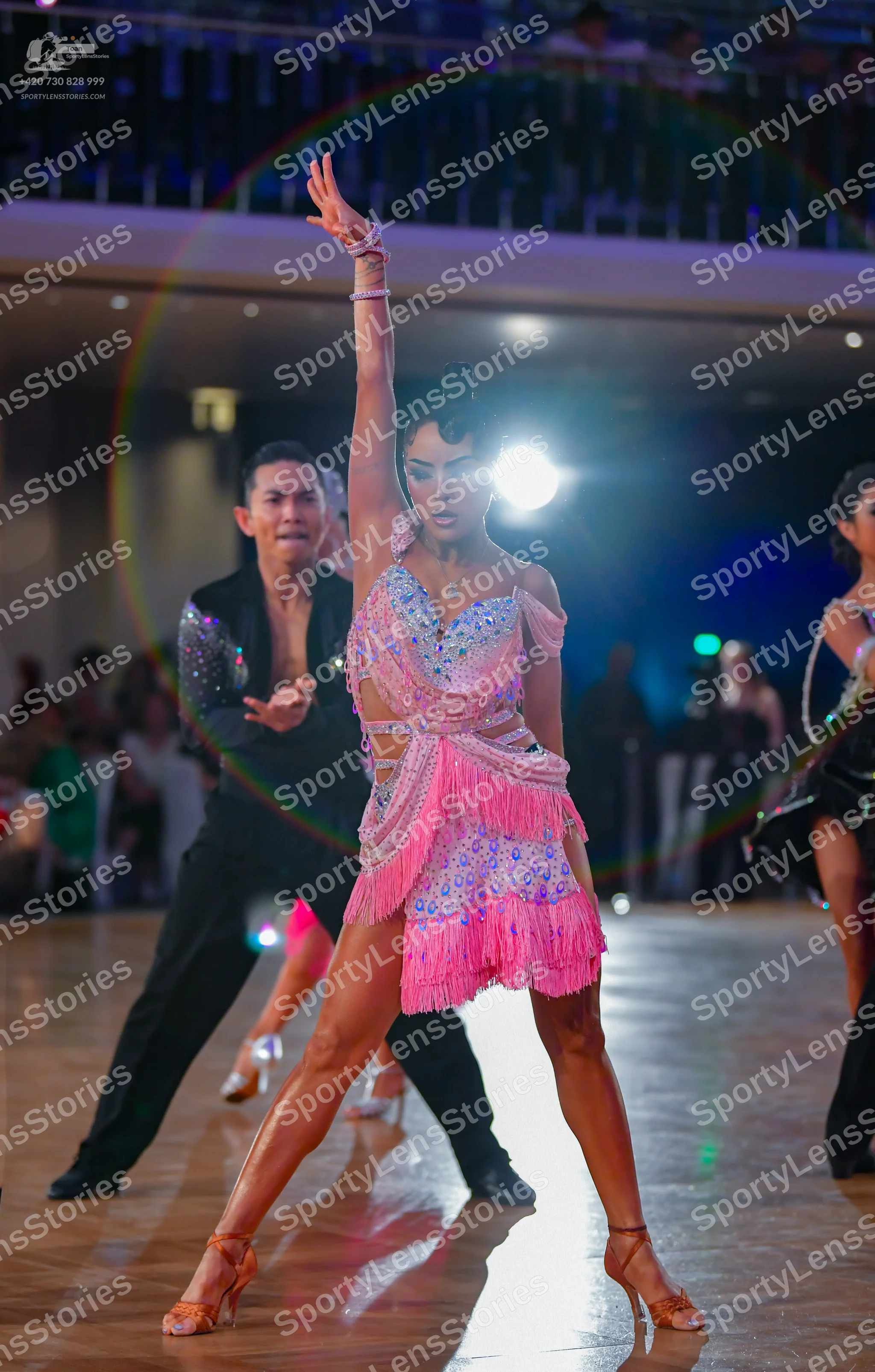 Dancesport competitor: Male dancer: black suit with silver sequins on the shoulder and sleeve