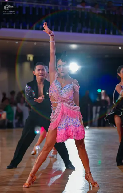 Dancesport competitor: Male dancer: black suit with silver sequins on the shoulder and sleeve