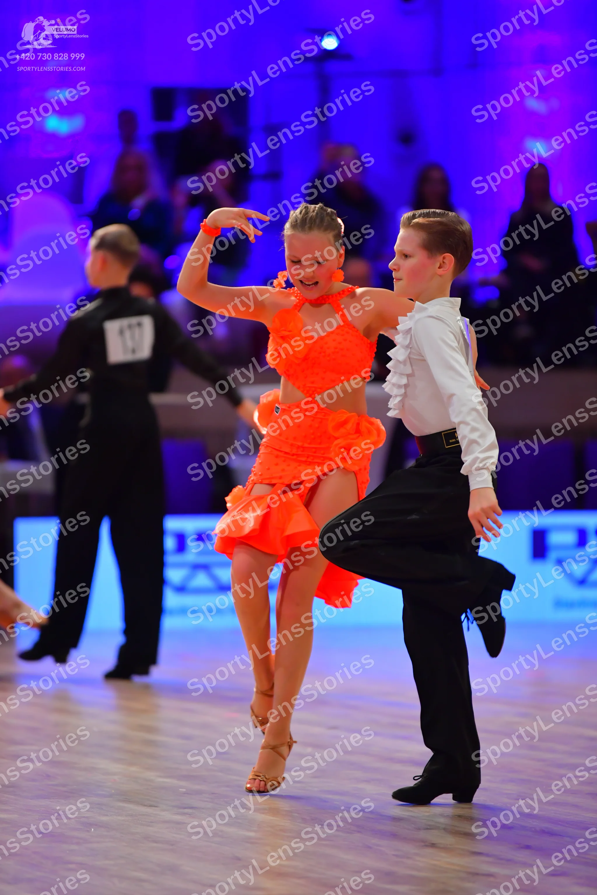 Dancesport competitor: Male dancer on left: black long-sleeved shirt and black trousers