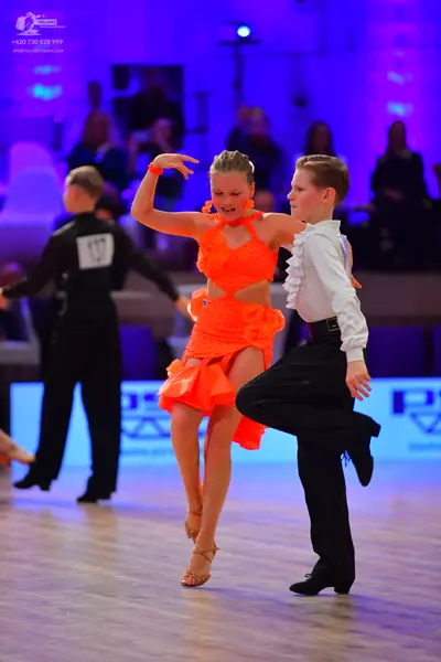 Dancesport competitor: Male dancer on left: black long-sleeved shirt and black trousers
