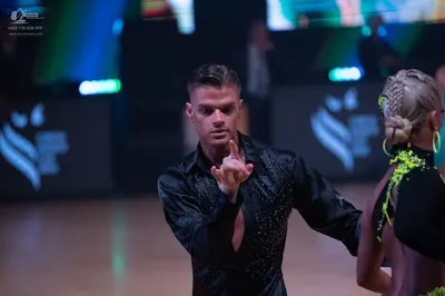 Dancesport competitor: Male dancer: black long-sleeved latin shirt with small crystals or sequins