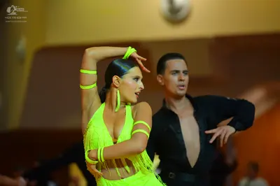 Dancesport competitor: Female dancer: neon yellow Latin dance dress with fringe and matching neon yello