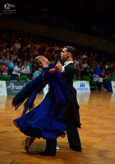 Dancesport competitor: Male dancer: black ballroom tailcoat with a white shirt and collar