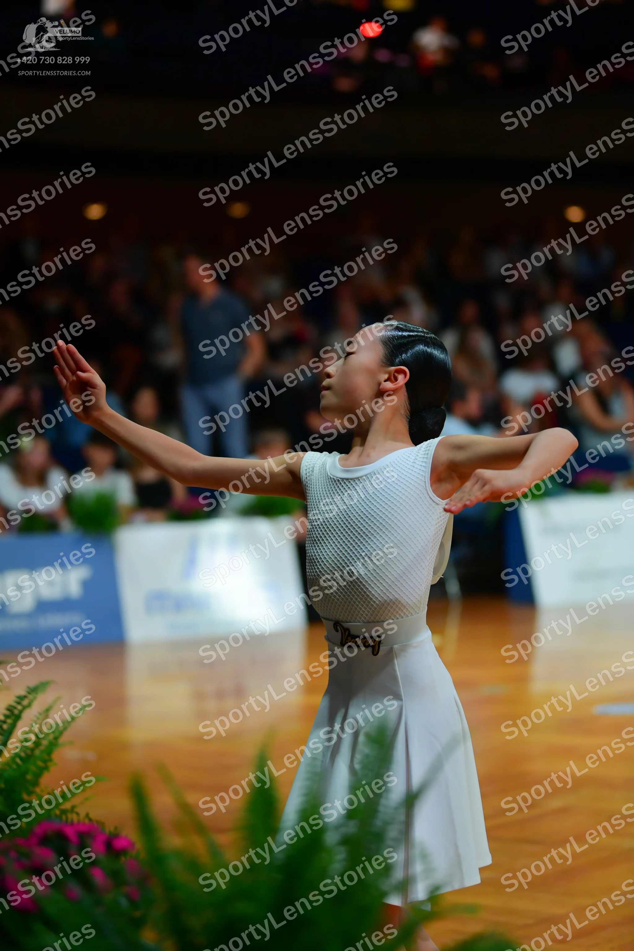 Dancesport competitor: Female dancer: white sleeveless dress with a ribbed top and a plain flared skirt