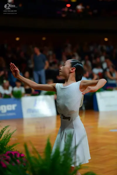 Dancesport competitor: Female dancer: white sleeveless dress with a ribbed top and a plain flared skirt