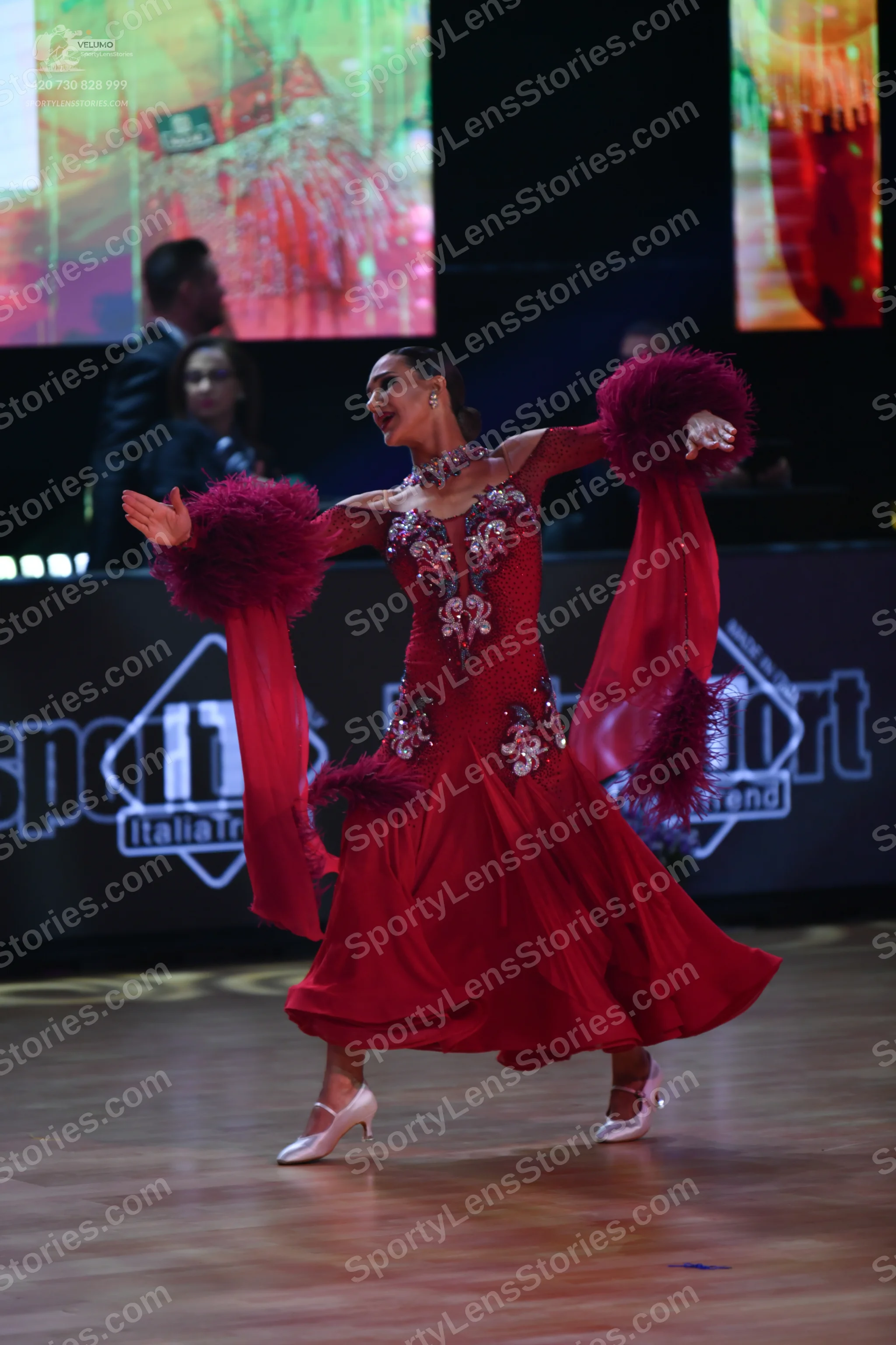 Dancesport competitor: Female dancer: red ballroom dress with silver and white sequin embellishments on