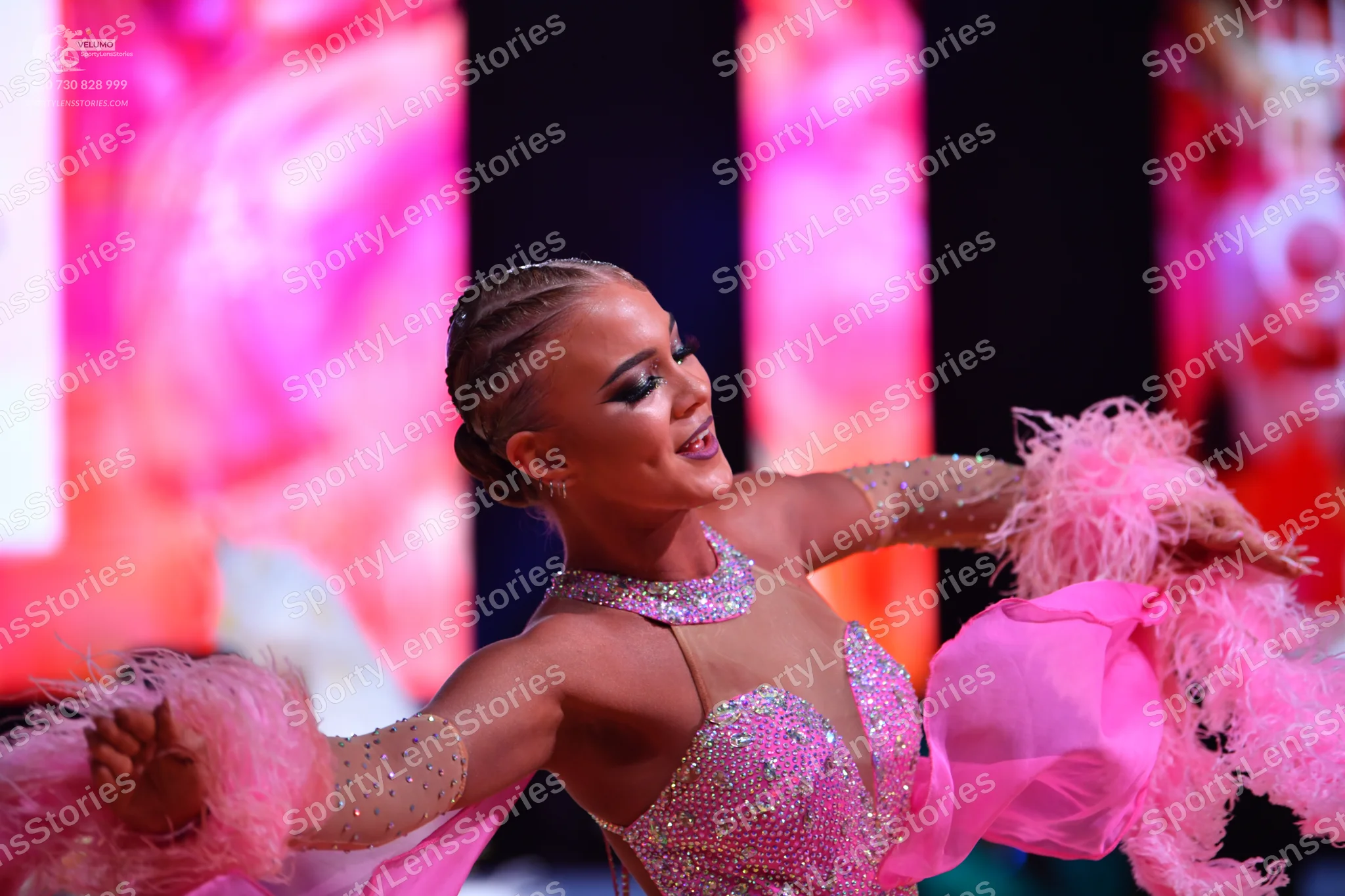 Dancesport competitor: Female dancer: light pink/lavender sequined Latin dress with an illusion necklin