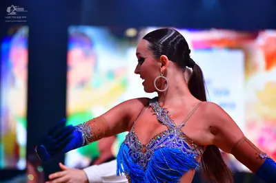 Dancesport competitor: Female dancer: Blue Latin dress with crystal/sequin embellishments, blue fringe,