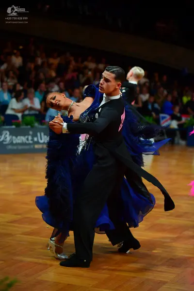 Dancesport competitor: Male dancer: black suit with black trousers and black shoes