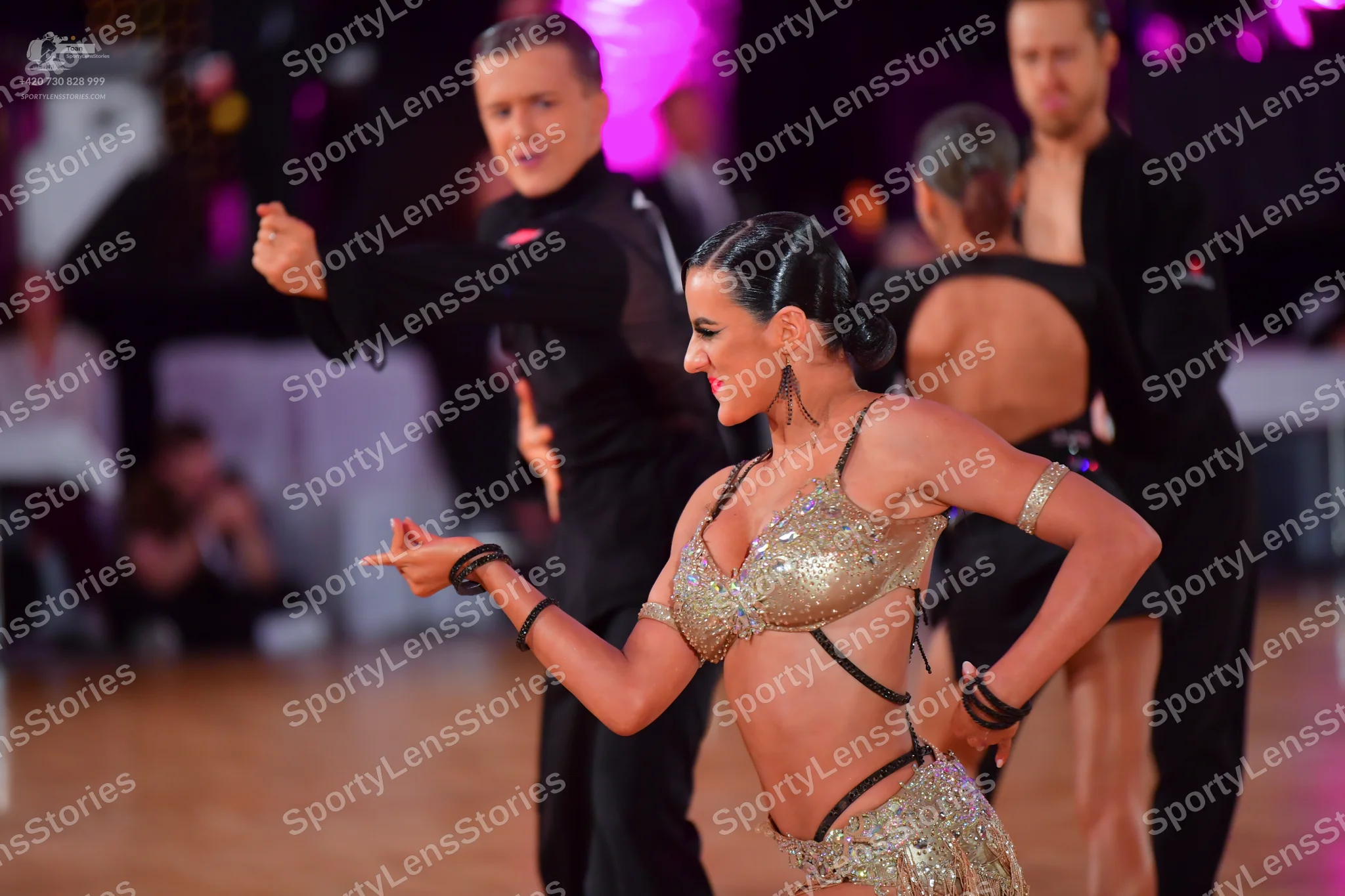Dancesport competitor: Male dancer (foreground): black long-sleeved shirt and black trousers