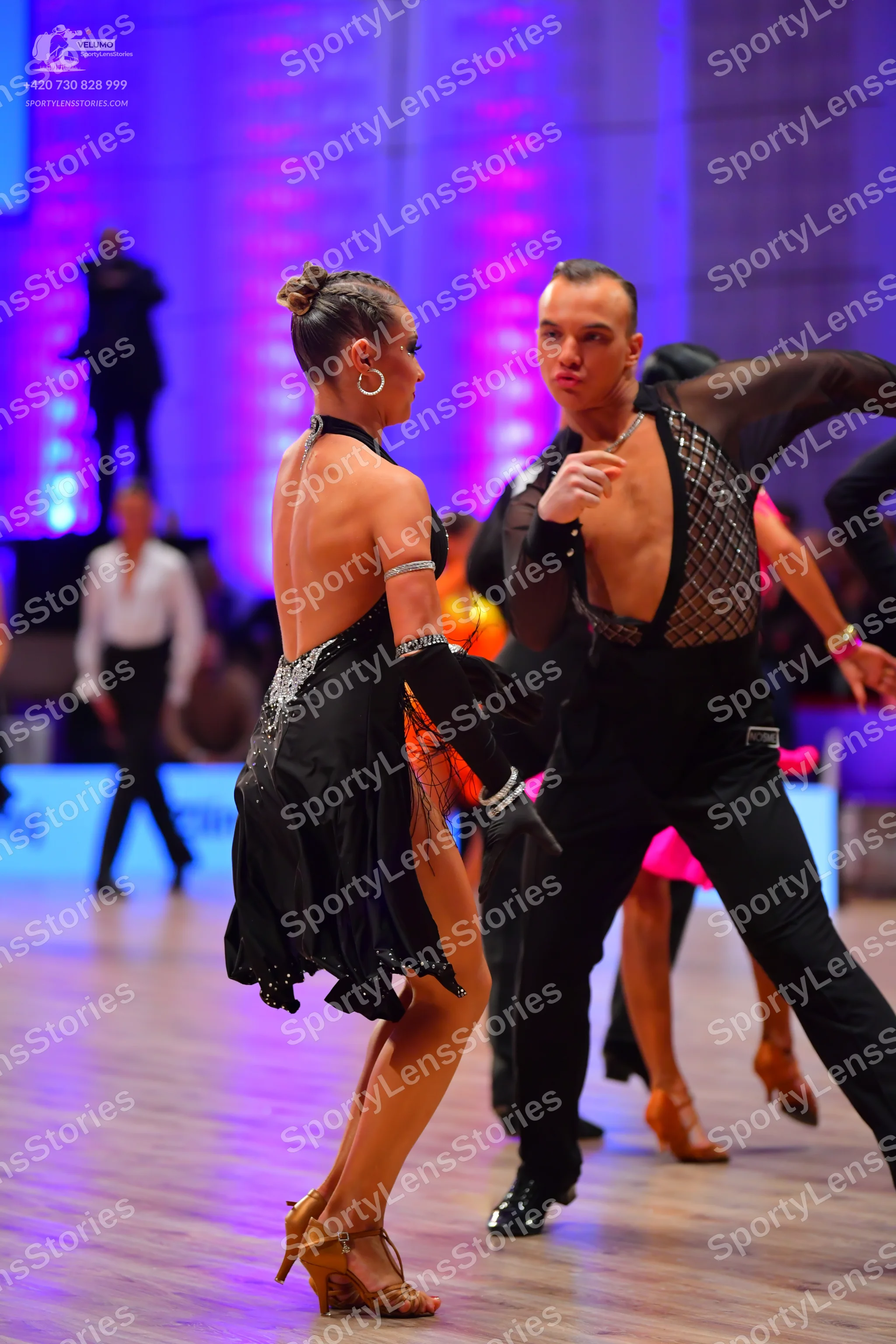 Dancesport competitor: Female dancer: black Latin dance dress with sequin embellishments, sleeveless, w