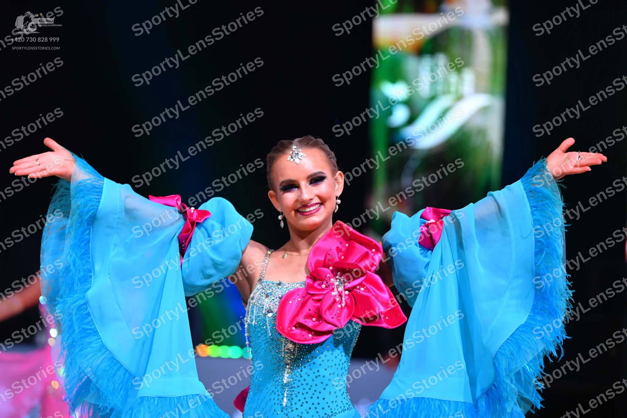Dancesport competitor: Female dancer: light blue Latin dance dress with sequins on the bodice, large fl