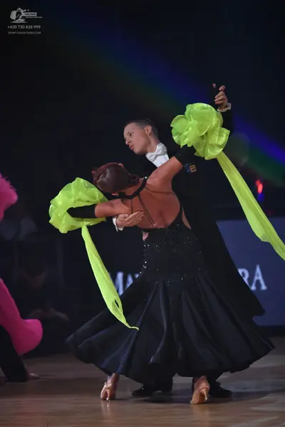 Dancesport competitor: Male dancer: black suit with white shirt and white bow tie