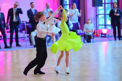 Dancesport competitor: Male dancer: white long-sleeved shirt and black trousers