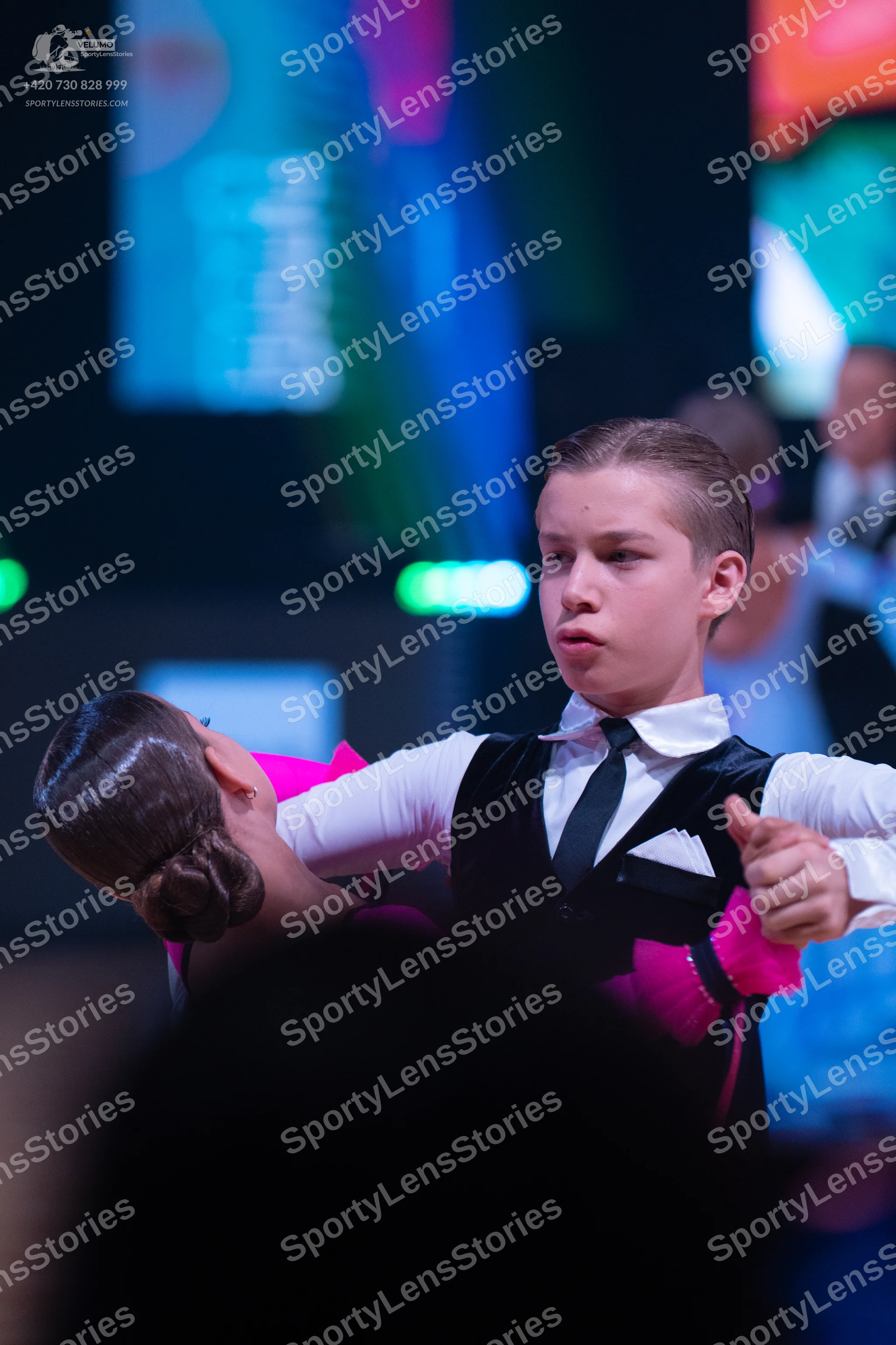 Dancesport competitor: Male dancer: white long-sleeved shirt, black vest, black necktie, and a white po