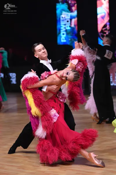 Dancesport competitor: Male dancer: black suit, white shirt, and white bow tie