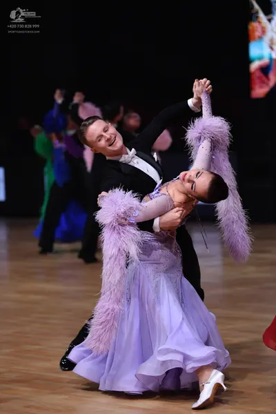 Dancesport competitor: Male dancer: black suit with a white shirt and white bowtie